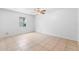 This bedroom features neutral paint, tile floors, a ceiling fan, and a window at 9130 Tudor Dr # M105, Tampa, FL 33615