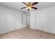 A bedroom with tile floor and a double door closet at 9130 Tudor Dr # M105, Tampa, FL 33615