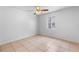 An empty bedroom with tile floor and ceiling fan at 9130 Tudor Dr # M105, Tampa, FL 33615