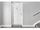 A gray doormat in front of a white front door with silver accents at 9130 Tudor Dr # M105, Tampa, FL 33615