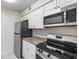 Updated kitchen features stainless steel appliances and modern countertops at 9130 Tudor Dr # M105, Tampa, FL 33615