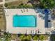 This aerial photo reveals a pool surrounded by lounge chairs and well-maintained landscaping at 9130 Tudor Dr # M105, Tampa, FL 33615