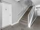 View of a carpeted stairwell in a home with a white front door at 9130 Tudor Dr # M105, Tampa, FL 33615