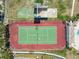 This aerial view showcases a well-maintained tennis court with surrounding foliage at 9130 Tudor Dr # M105, Tampa, FL 33615
