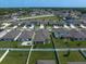 Aerial view of homes with lush green yards, white fences, and neighborhood amenities, surrounded by greenbelts at 9647 Summers Cay Cir, Thonotosassa, FL 33592