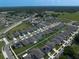 Enjoy an aerial shot of a cozy neighborhood boasting well-kept lawns, safe streets, and modern homes with grey rooftops at 9647 Summers Cay Cir, Thonotosassa, FL 33592