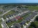 Aerial view showcases a neighborhood with well-maintained homes, tree-lined streets, and proximity to green spaces and schools at 9647 Summers Cay Cir, Thonotosassa, FL 33592