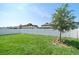Expansive backyard features lush green grass, a privacy fence, and a young tree, perfect for outdoor activities at 9647 Summers Cay Cir, Thonotosassa, FL 33592