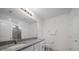 Well-lit bathroom features double sinks, granite countertops, and a walk-in shower with tiled walls at 9647 Summers Cay Cir, Thonotosassa, FL 33592