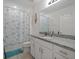 Well-lit bathroom features modern fixtures, granite countertops, and a shower with a starfish curtain at 9647 Summers Cay Cir, Thonotosassa, FL 33592
