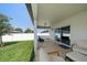 Spacious covered patio with outdoor seating, providing a comfortable area for relaxing and entertaining in the backyard at 9647 Summers Cay Cir, Thonotosassa, FL 33592