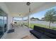 Inviting covered patio with a full furniture set and ample space for relaxing and enjoying the backyard view at 9647 Summers Cay Cir, Thonotosassa, FL 33592