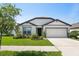 Charming single-story home features a well-maintained lawn, two-car garage, and inviting front entrance at 9647 Summers Cay Cir, Thonotosassa, FL 33592