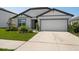 Attractive home with a two-car garage, well-manicured lawn, and tasteful landscaping enhancing its curb appeal at 9647 Summers Cay Cir, Thonotosassa, FL 33592