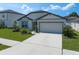 Charming home with a well-maintained front yard, a two-car garage, and beautiful landscaping, offering a welcoming entrance at 9647 Summers Cay Cir, Thonotosassa, FL 33592