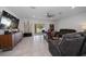 Open living room featuring tile floors, ceiling fan and sliding glass doors to the patio at 9647 Summers Cay Cir, Thonotosassa, FL 33592