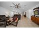 Spacious living room with tile floors, ceiling fan and convenient access to the kitchen at 9647 Summers Cay Cir, Thonotosassa, FL 33592