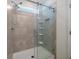 Modern bathroom shower features tiled walls, a glass door, and built-in shelves at 9647 Summers Cay Cir, Thonotosassa, FL 33592