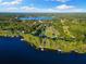 An aerial view shows a home situated on an expansive property bordered by a serene lake at 18258 Wayne Rd, Odessa, FL 33556