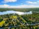 Aerial view of the property showing the lakefront location and the expansive, tree-lined grounds at 18258 Wayne Rd, Odessa, FL 33556