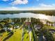 An aerial view of the home showing its prime location on a lakefront property with lush landscaping at 18258 Wayne Rd, Odessa, FL 33556