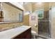 Stylish bathroom with decorative wallpaper, a vanity sink, and a glass-enclosed shower stall at 18258 Wayne Rd, Odessa, FL 33556