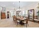 Elegant dining room featuring a chandelier, wood table, and display case with fine china at 18258 Wayne Rd, Odessa, FL 33556