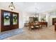Dining room with tile flooring, chandelier, and decorative front door with stained glass at 18258 Wayne Rd, Odessa, FL 33556