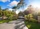 Inviting driveway with an ornate gate, manicured landscaping, and a clear view of the home's address at 18258 Wayne Rd, Odessa, FL 33556