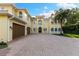Elegant two-story home with a spacious driveway, showcasing its beautiful facade and three car garage for ample parking at 18258 Wayne Rd, Odessa, FL 33556