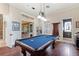 Game room with a pool table and an adjacent powder room for convenience at 18258 Wayne Rd, Odessa, FL 33556