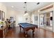 Spacious game room with a pool table and convenient access to the outdoor living area at 18258 Wayne Rd, Odessa, FL 33556