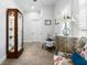 Bright hallway featuring a display cabinet, comfortable chairs, and decorative flower arrangements at 18258 Wayne Rd, Odessa, FL 33556