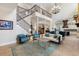 Grand living room with soaring ceilings, elegant staircase, and designer furnishings at 18258 Wayne Rd, Odessa, FL 33556