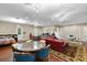 Bright living area with a red leather sofa, dining area, hardwood floors and charming decor at 18258 Wayne Rd, Odessa, FL 33556