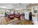 Spacious room with hardwood floors, stylish red furniture, built-in shelves, and ample natural light at 18258 Wayne Rd, Odessa, FL 33556