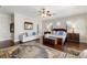 Well-lit main bedroom featuring a sitting area, ceiling fan, and ensuite bath at 18258 Wayne Rd, Odessa, FL 33556
