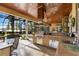 Elegant outdoor kitchen with grill, bar seating, and stunning views of the lake and pool at 18258 Wayne Rd, Odessa, FL 33556