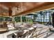 Outdoor living area showcasing the pool, covered seating, and stunning lake views at 18258 Wayne Rd, Odessa, FL 33556