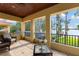Expansive covered patio with lake views, tile flooring, ceiling fan, and comfortable seating at 18258 Wayne Rd, Odessa, FL 33556
