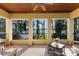 Covered patio overlooking lake featuring tile floor, ceiling fan, and outdoor seating at 18258 Wayne Rd, Odessa, FL 33556