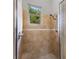 Tiled walk-in shower with glass door, and mounted shower head at 18258 Wayne Rd, Odessa, FL 33556