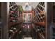 Wine cellar showcasing a variety of wines with a decorative fan and overhead lighting at 18258 Wayne Rd, Odessa, FL 33556