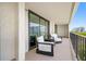 A balcony with patio chairs, offering an outdoor seating area, providing a place to relax and enjoy views at 100 Oakmont Ln # 802, Belleair, FL 33756
