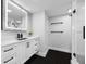 Modern bathroom with marble countertops, updated lighting and hardware, and dark hardwood floors at 100 Oakmont Ln # 802, Belleair, FL 33756
