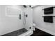 Modern bathroom with a glass enclosed shower, black accents, and sleek design at 100 Oakmont Ln # 802, Belleair, FL 33756