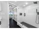 Modern bathroom boasts a glass-enclosed shower with black hardware and black tile flooring at 100 Oakmont Ln # 802, Belleair, FL 33756