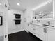 Modern bathroom with a double vanity and large framed mirrors at 100 Oakmont Ln # 802, Belleair, FL 33756