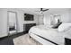 Bright bedroom with king bed, dark wood floors, and flat screen TV at 100 Oakmont Ln # 802, Belleair, FL 33756