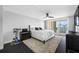 Bright bedroom featuring a king bed, balcony access, and sleek modern furnishings at 100 Oakmont Ln # 802, Belleair, FL 33756